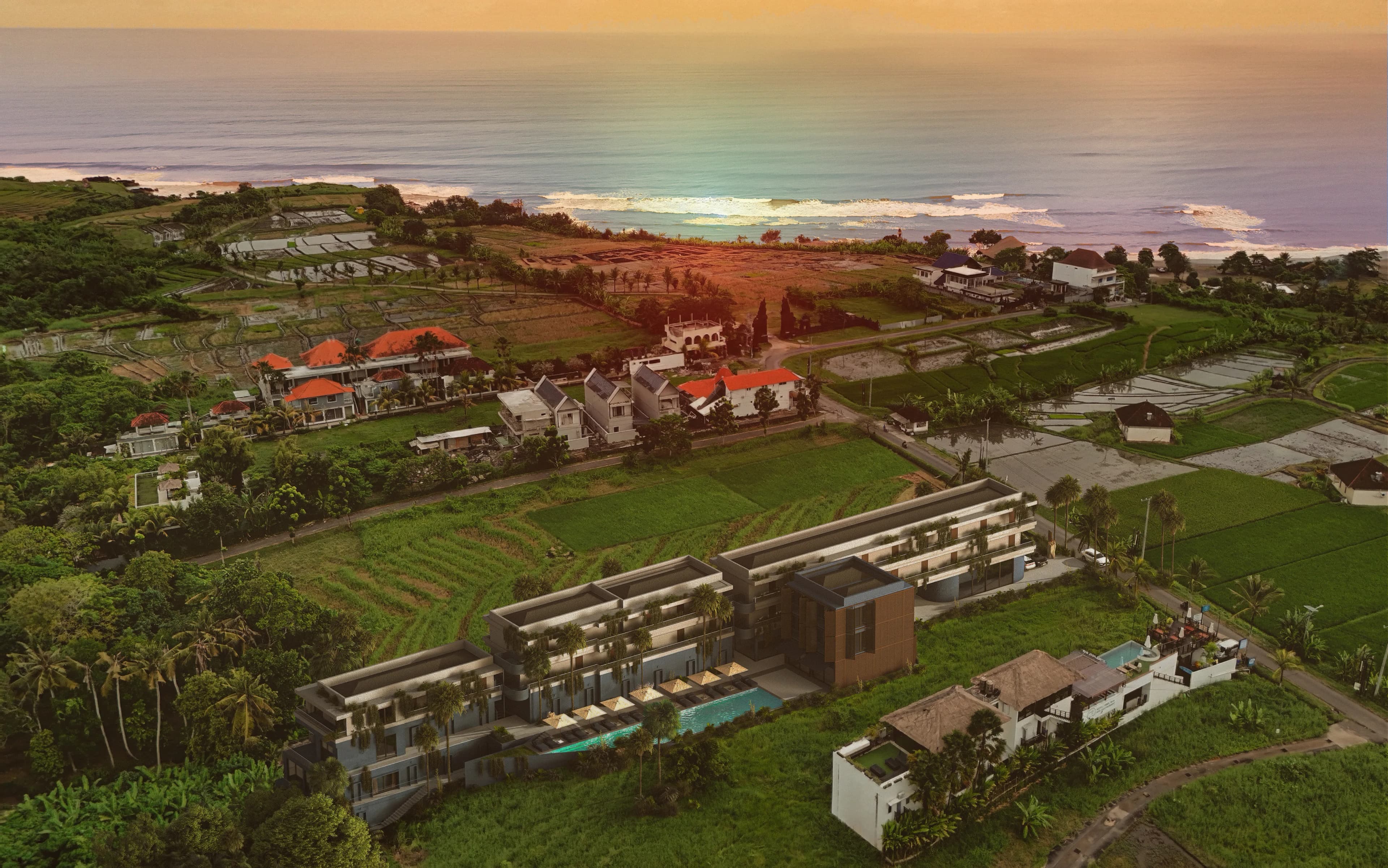 An aerial view of the lush landscape and coastline of Canggu, Bali.